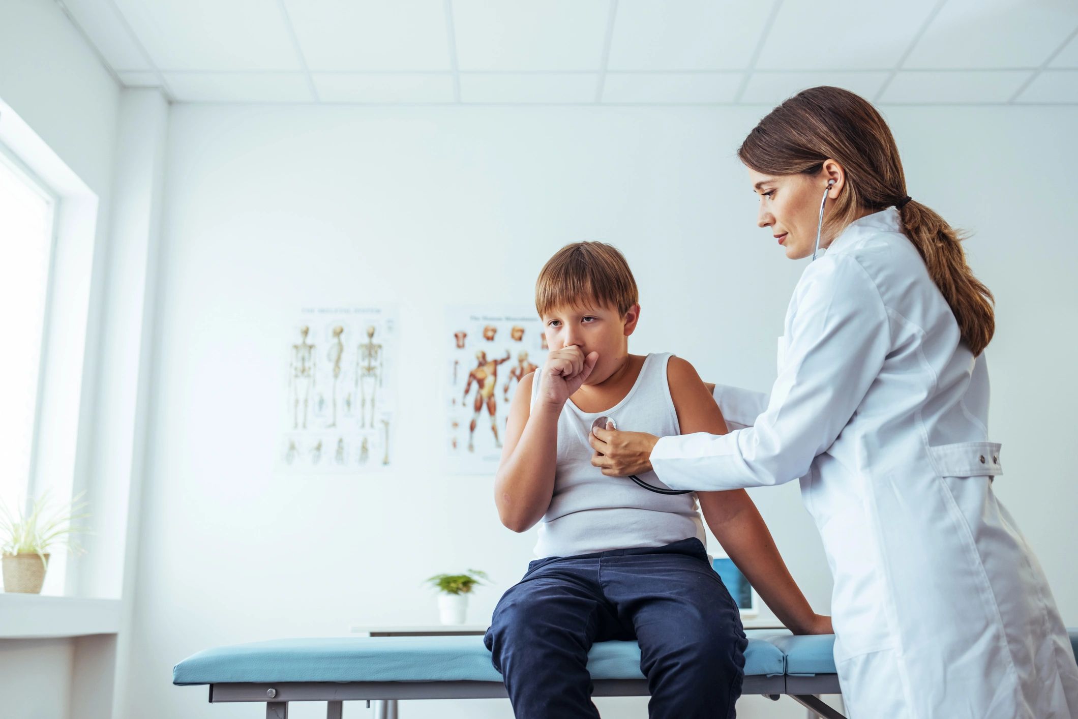 Clinician speaking with a child during a checkup